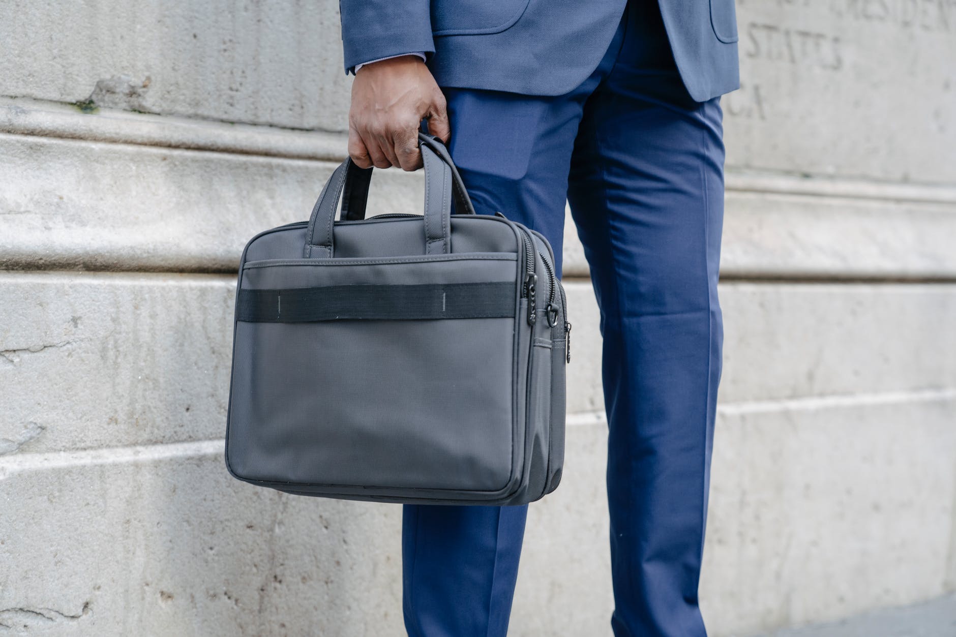 a person in a suit holding a briefcase